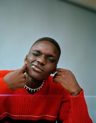 a woman in a red sweater sitting down