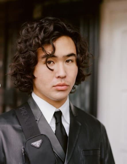 a young man wearing a suit and tie