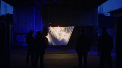 a group of people standing in front of a screen