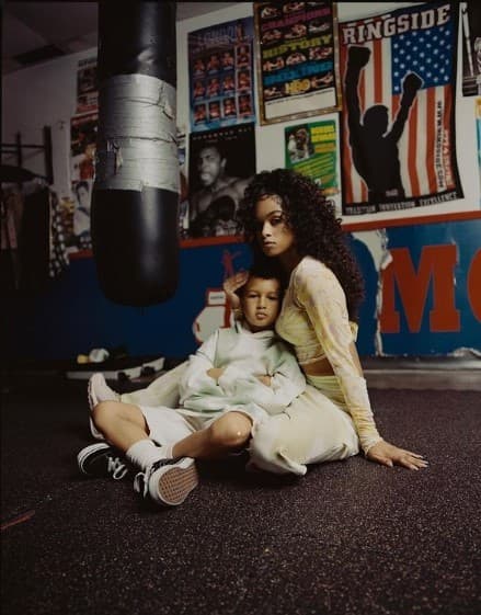 a woman sitting on the ground with a child