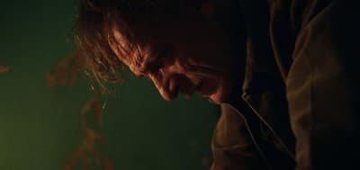 a man looking down at a piece of paper