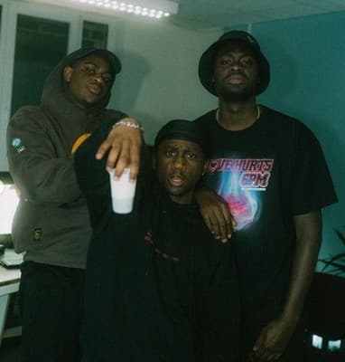a group of three men standing next to each other