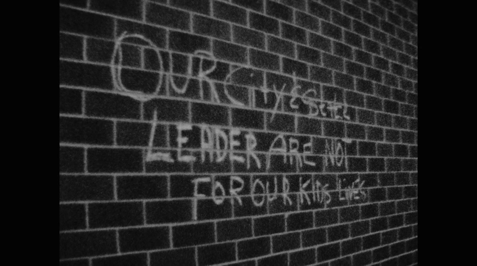 a brick wall with graffiti written on it