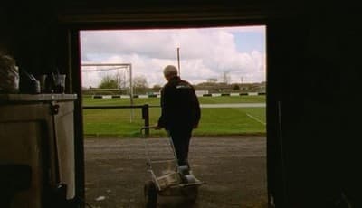 a man standing in a doorway with a mop