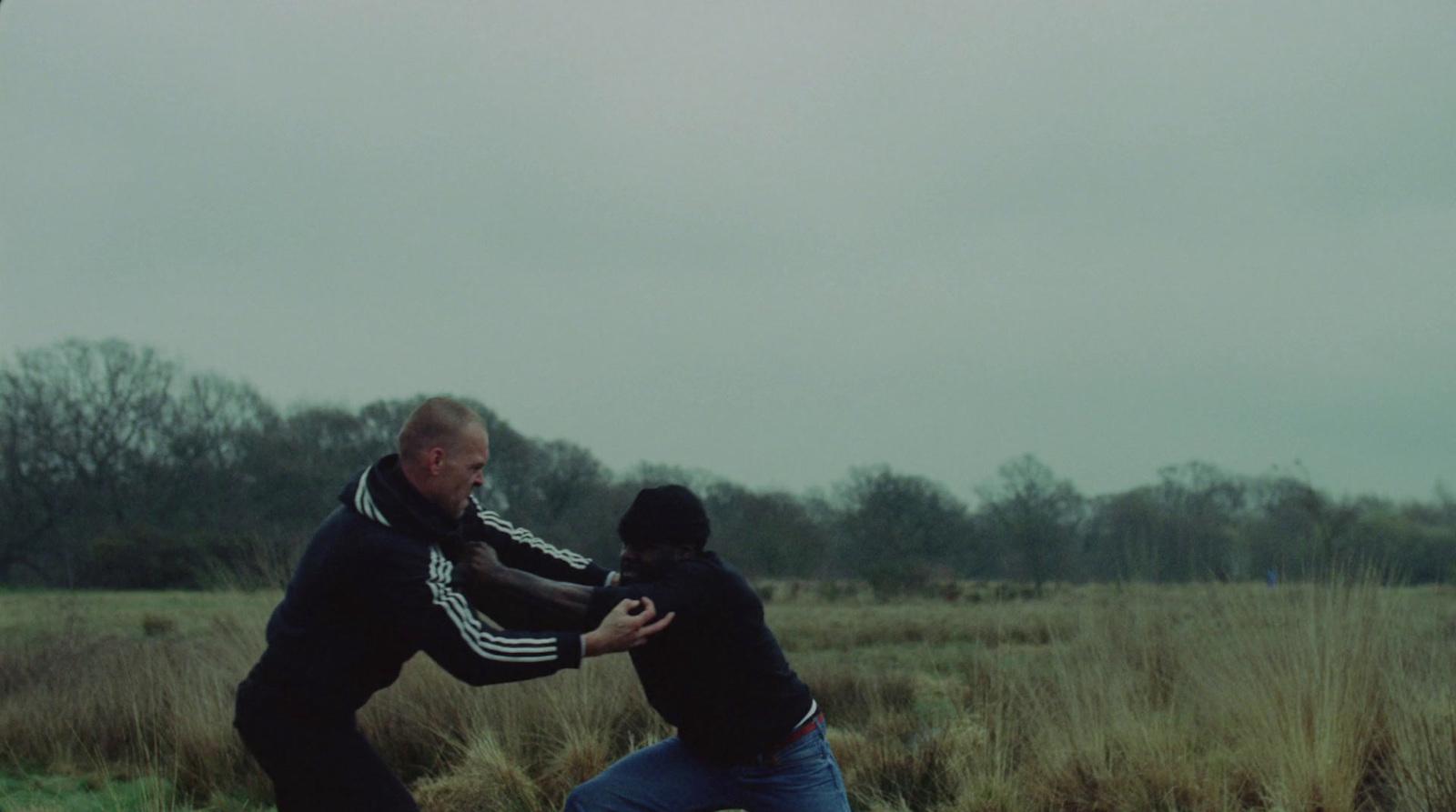 two men in a field playing with a frisbee