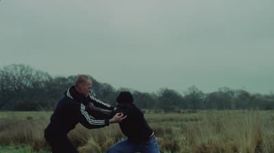 two men in a field playing with a frisbee