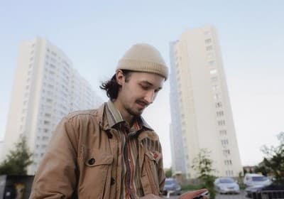 a man in a hat looking at his cell phone