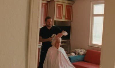 a man standing next to a woman in a room