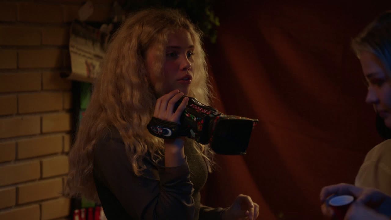 a woman holding a camera in her right hand