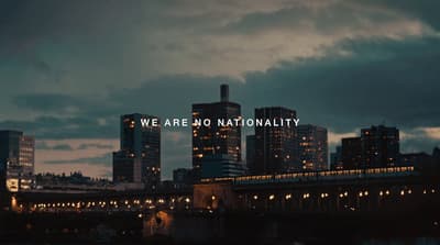 a picture of a city at night with the words we are no nationality