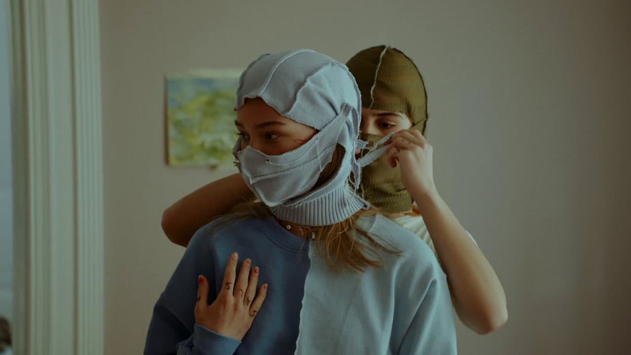 a woman with a bandage on her head and another woman covering her face with a