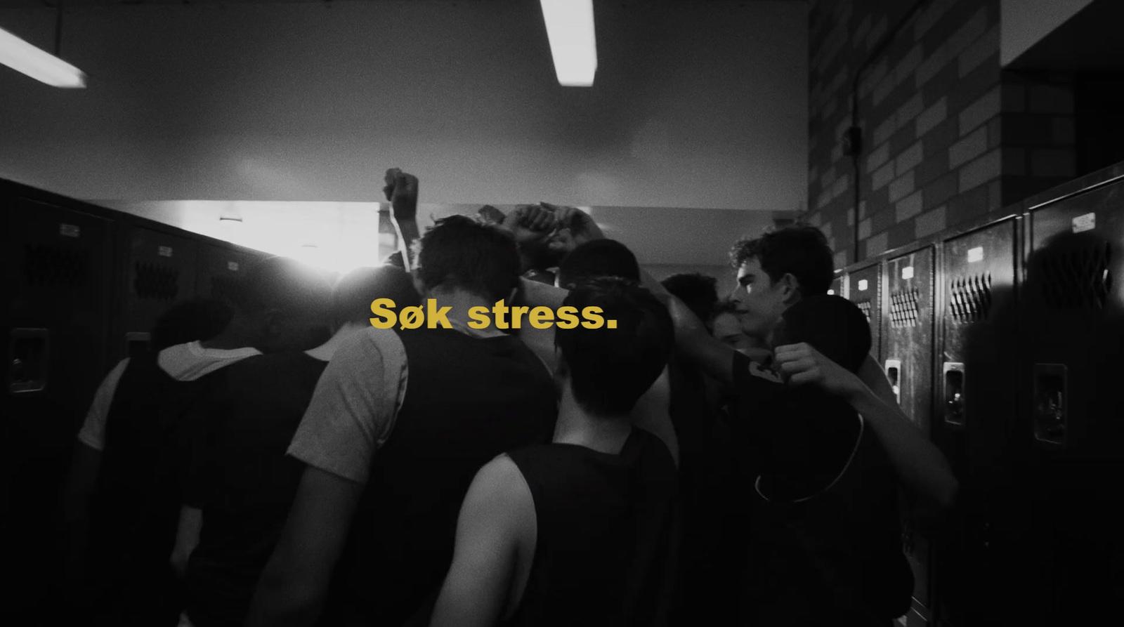 a group of people standing around each other in a room