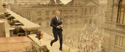 a man in a suit is standing on a ledge