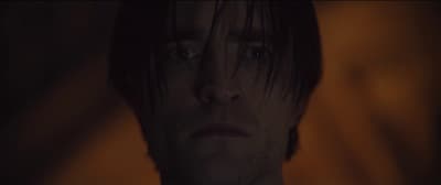a close up of a person in a dark room