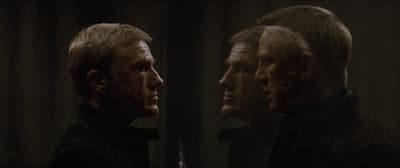 two men standing next to each other in front of a mirror
