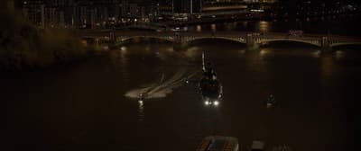 a boat traveling down a river at night