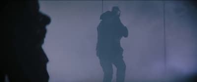 a person standing in a foggy room with a cell phone