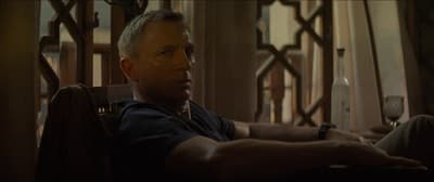 a man sitting in a chair with a glass of wine