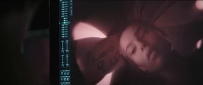 a blurry photo of a woman's face and arm