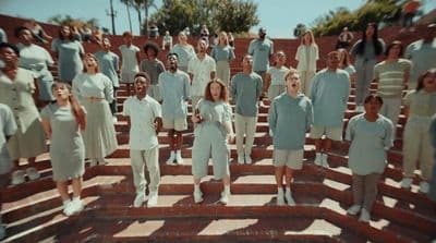 a group of people standing on top of a set of stairs