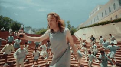 a group of people are running down a set of steps