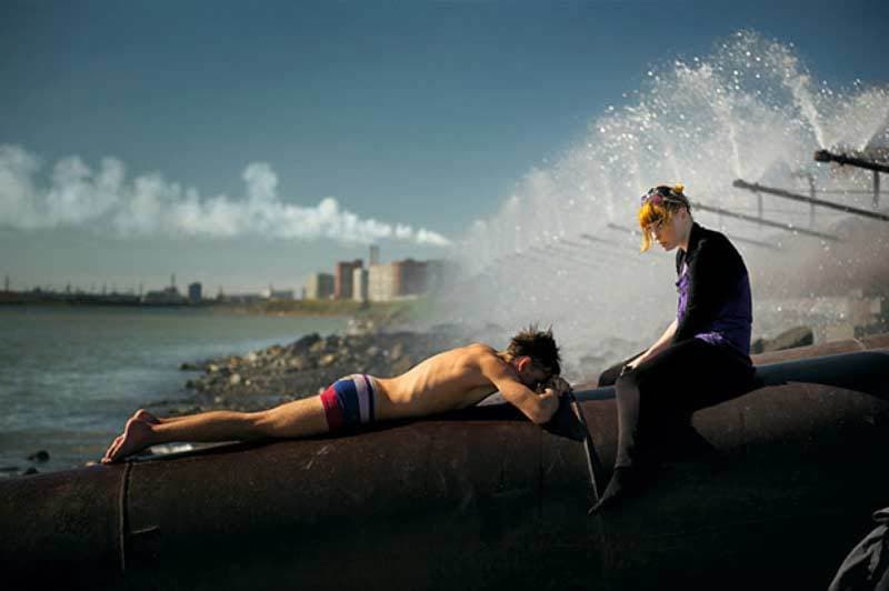 a couple of people that are laying on a wall