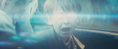 a boy with his mouth open in a car