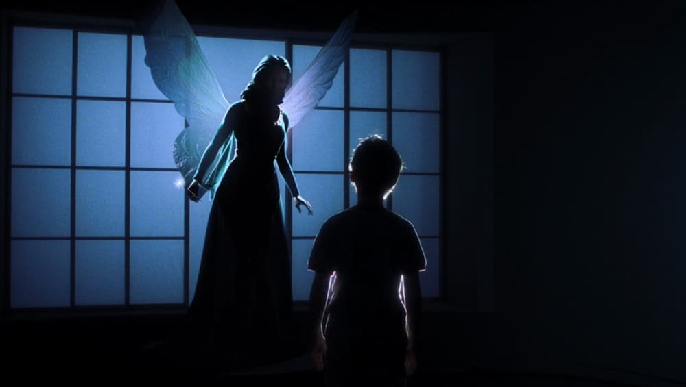 a woman standing next to a child in front of a window