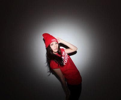 a woman in a red hat is posing for a picture