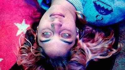 a woman laying on the floor with her eyes open