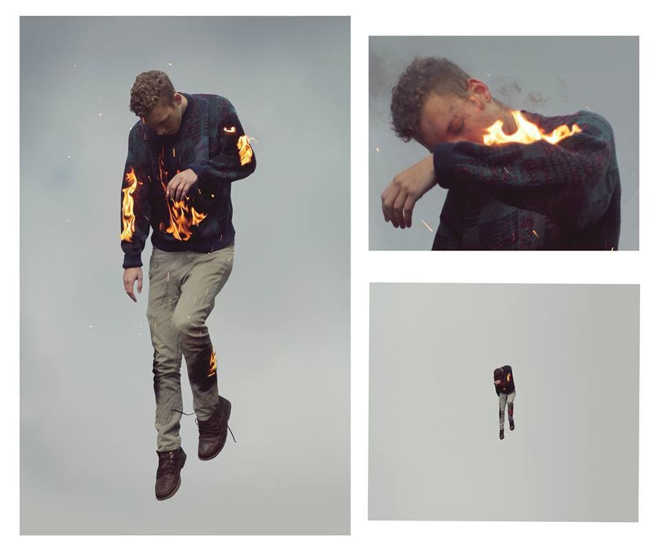 a man flying through the air while holding onto a fire hose