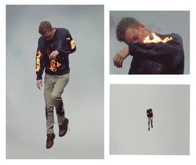 a man flying through the air while holding onto a fire hose