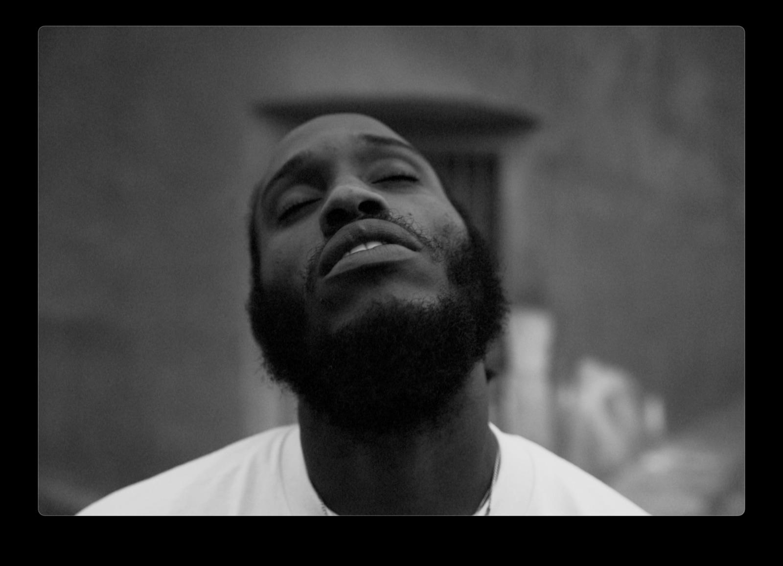 a black and white photo of a man with a beard