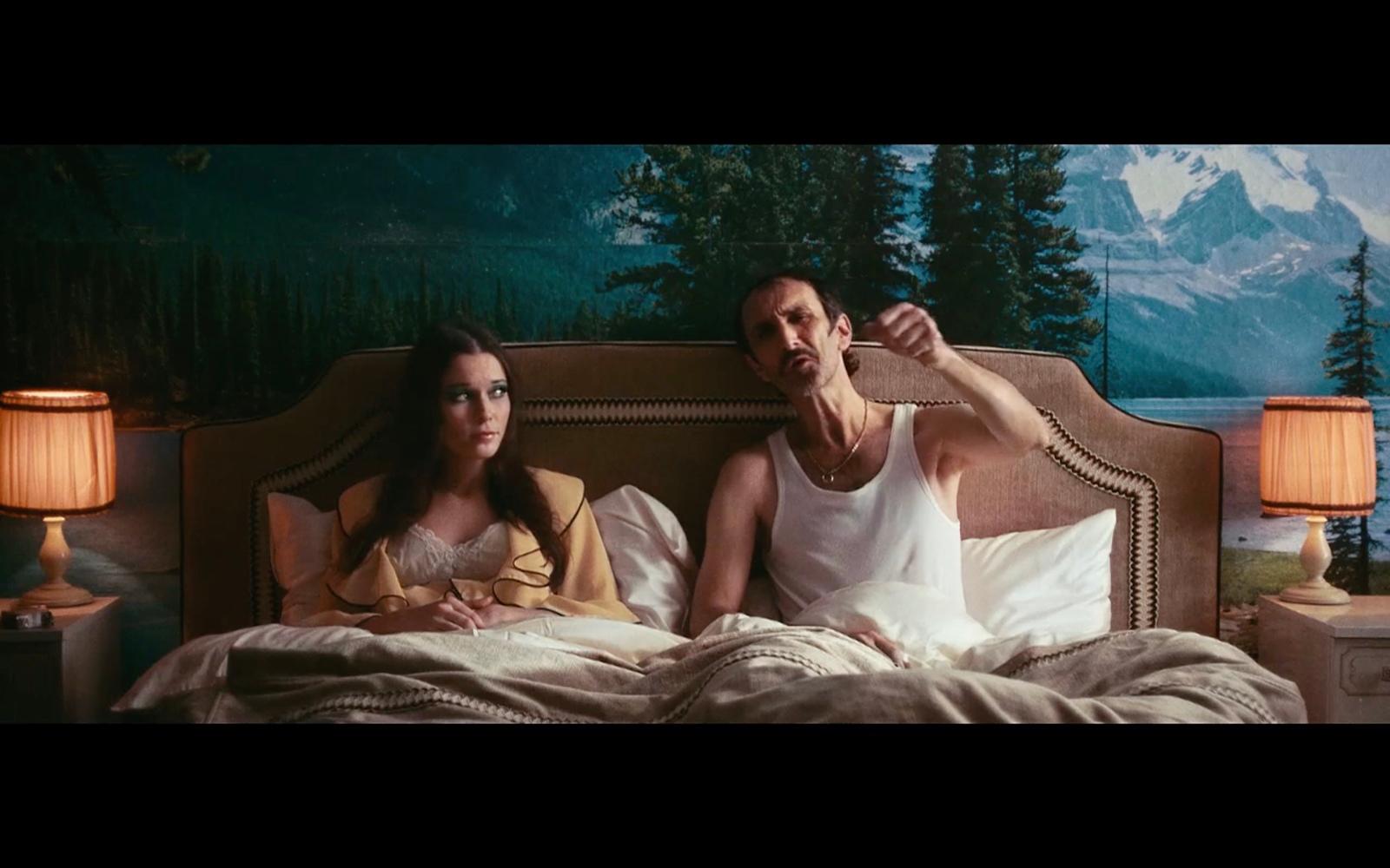 a man and a woman laying in a bed