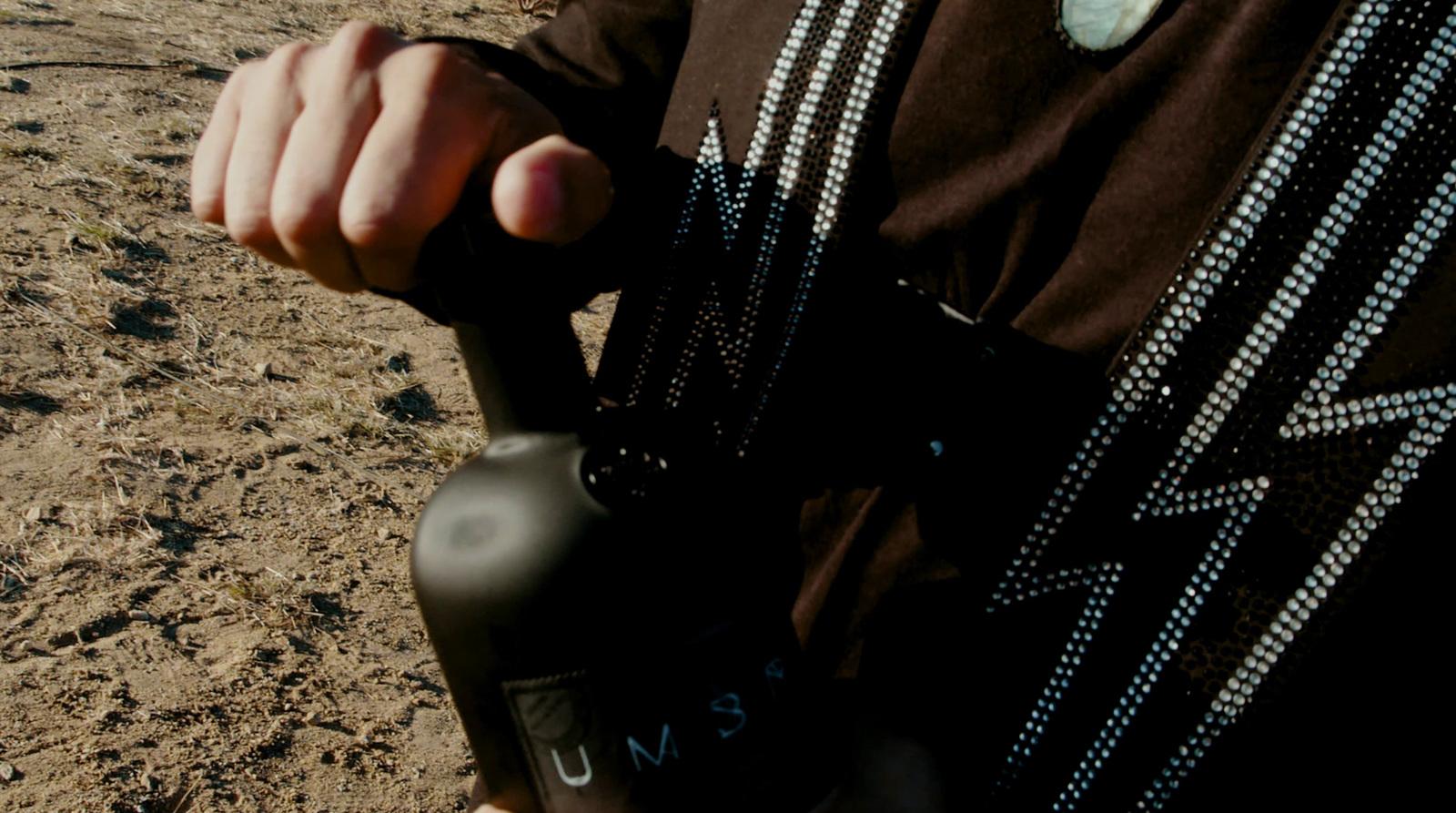 a man holding a black object in his hand