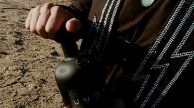 a man holding a black object in his hand