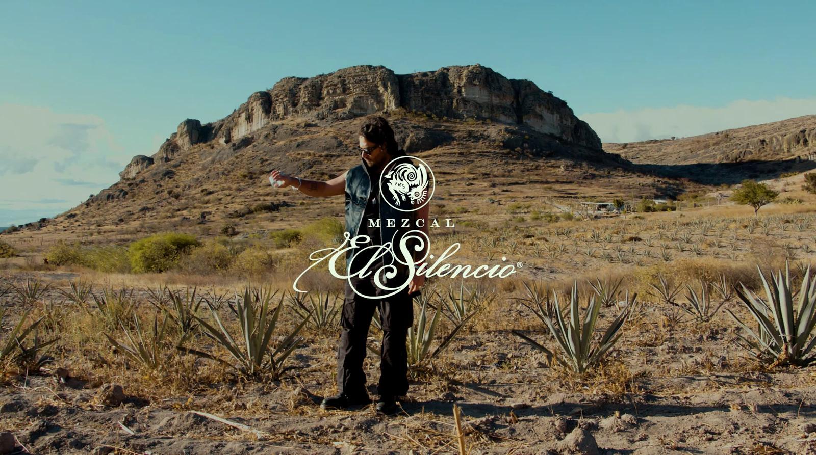 a man standing in the middle of a desert