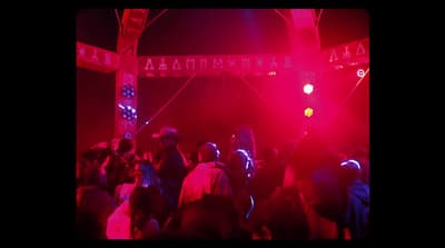 a crowd of people standing around a red light