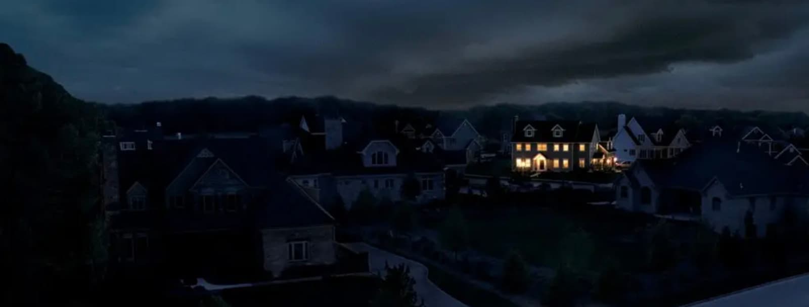 a night time view of a house with lights on