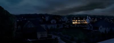 a night time view of a house with lights on