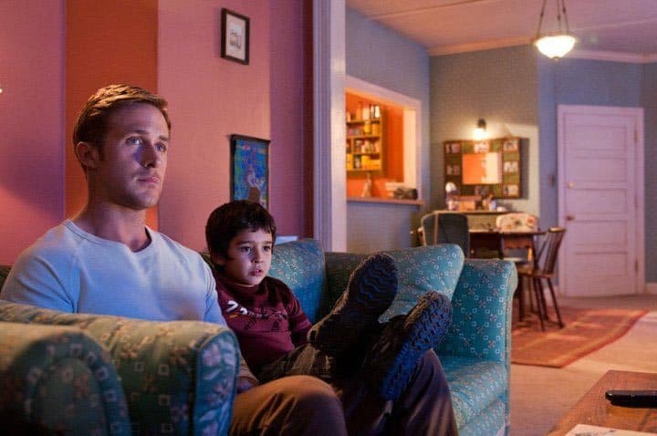 a man and a child sitting on a couch in a living room