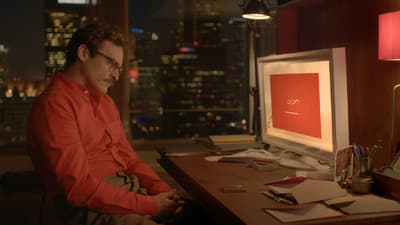 a man sitting at a desk in front of a computer