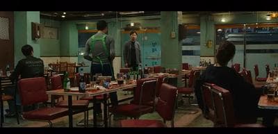 a group of people sitting at a table in a restaurant
