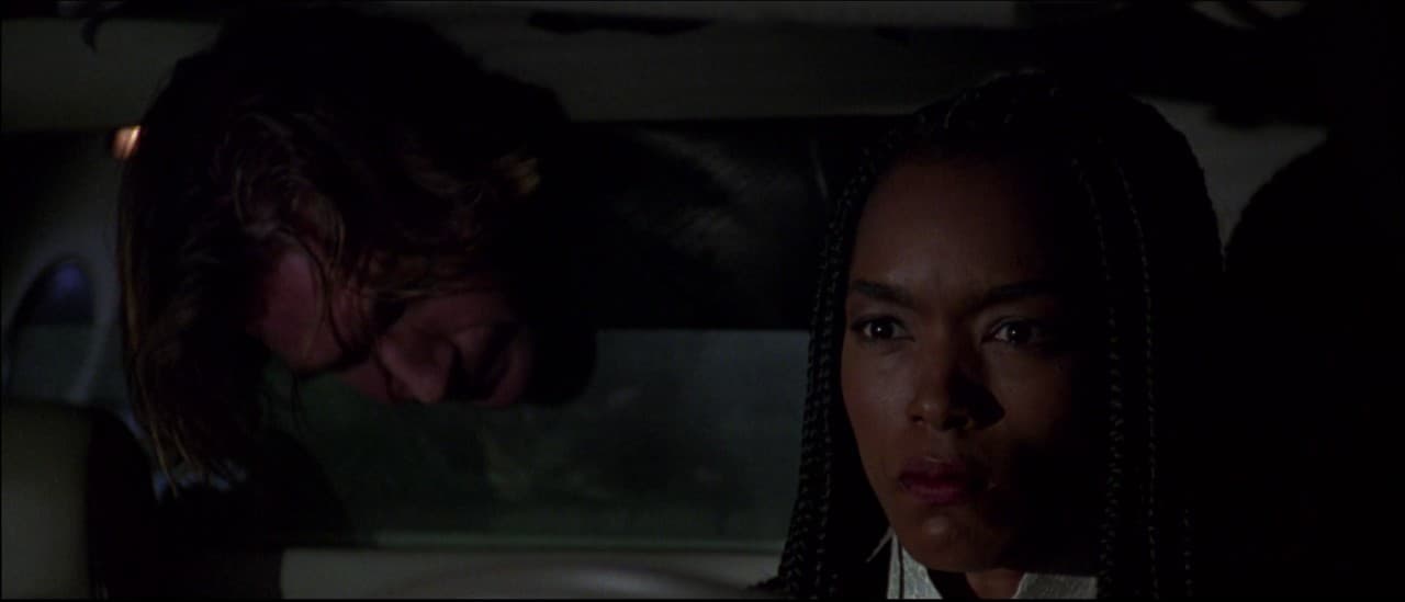 a man and a woman in a car looking at each other