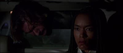 a man and a woman in a car looking at each other