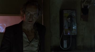 a man standing in a room next to a phone