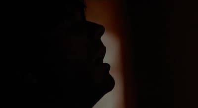 a silhouette of a person in the dark