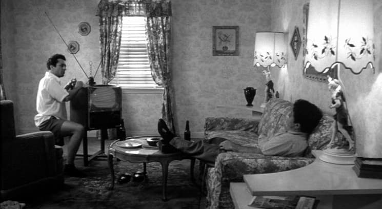 a man sitting on a couch in a living room