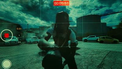 a man sitting on a motorcycle in a parking lot
