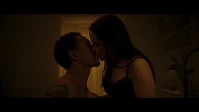 a man and a woman kissing in a dark room